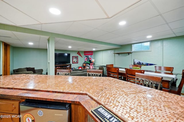 kitchen with recessed lighting, open floor plan, and a drop ceiling