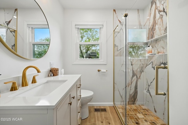 2636 Debbie Dr, Elida, OH 45807 - full bathroom featuring a marble finish shower, toilet, vanity, wood finished floors, and baseboards