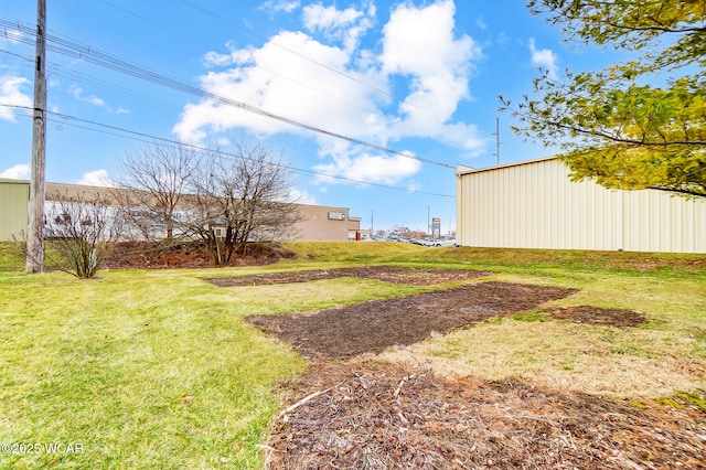 view of yard featuring an outdoor structure and an outbuilding