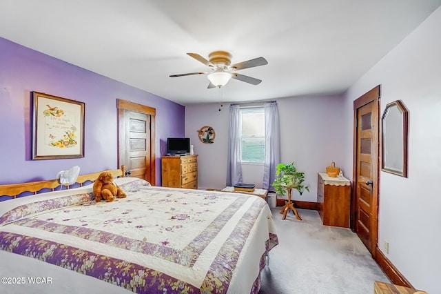 carpeted bedroom featuring baseboards and ceiling fan