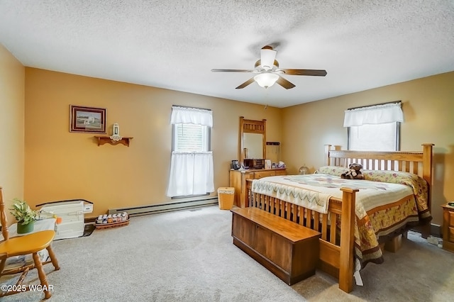 bedroom featuring a baseboard heating unit, light carpet, a ceiling fan, and a textured ceiling