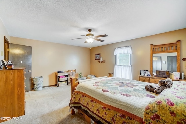 bedroom with light carpet, baseboards, a textured ceiling, and a ceiling fan