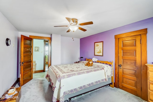 carpeted bedroom with baseboards and a ceiling fan