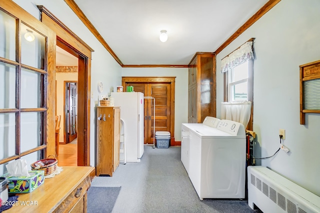 laundry area featuring laundry area, ornamental molding, radiator heating unit, and washing machine and clothes dryer