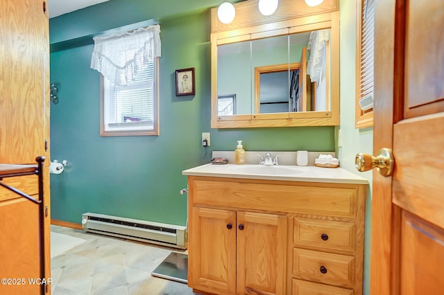 bathroom featuring a baseboard heating unit and vanity