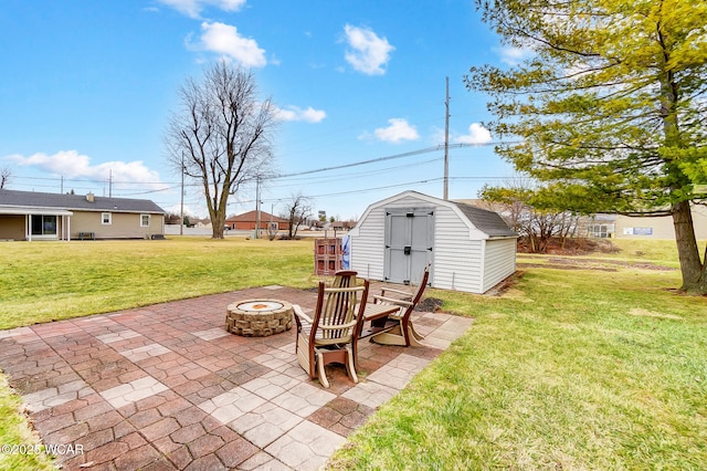 view of patio / terrace featuring an outdoor structure, a shed, and an outdoor fire pit