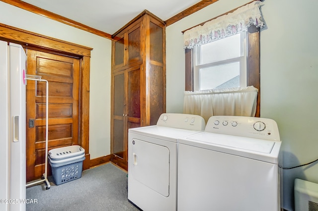 laundry area featuring washer and clothes dryer, cabinet space, and carpet