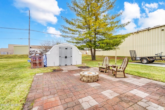 view of patio with an outdoor structure, a storage unit, and an outdoor fire pit