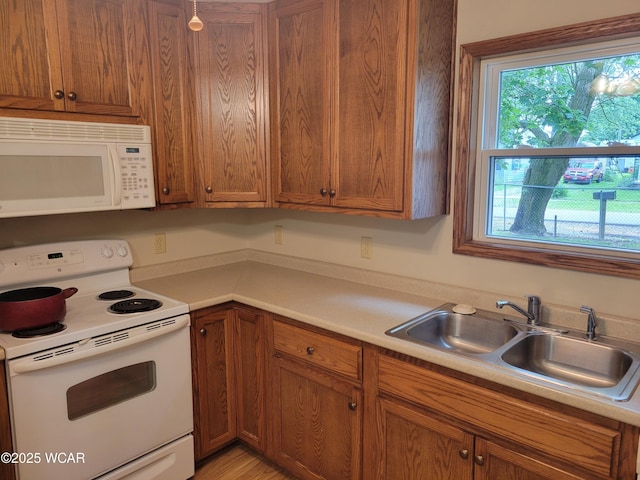 440 Edwards St, Ada, OH 45810 - kitchen with white appliances, light countertops, and brown cabinets