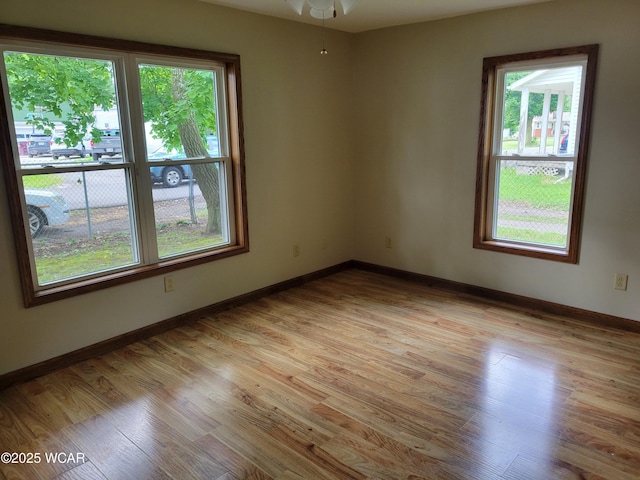 440 Edwards St, Ada, OH 45810 - empty room featuring plenty of natural light, light wood-style floors, and ceiling fan