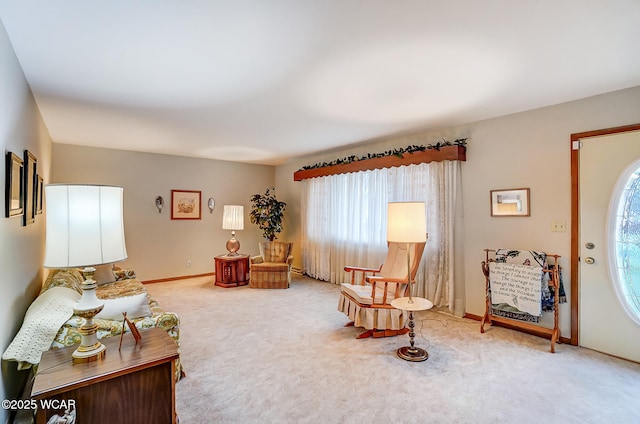 sitting room with a wealth of natural light and carpet