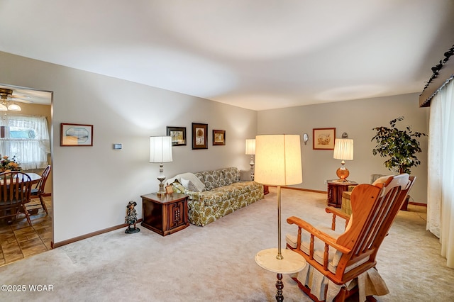 carpeted living room with ceiling fan