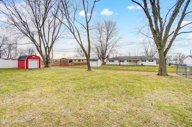 view of yard with a garage and a shed