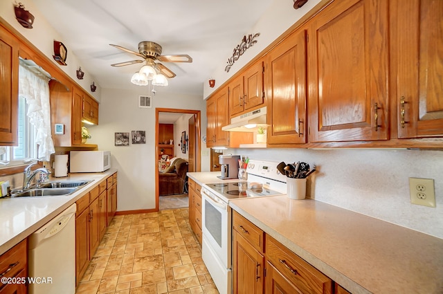 kitchen featuring sink, white appliances, and ceiling fan