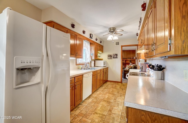 kitchen featuring sink, white appliances, and ceiling fan