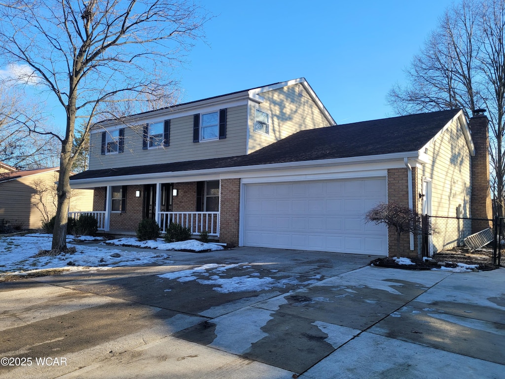 view of front property with a garage and a porch