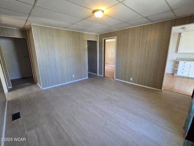 939 N W St, Lima, OH 45801 - unfurnished bedroom featuring a paneled ceiling, wood walls, and wood finished floors