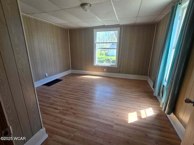 939 N W St, Lima, OH 45801 - unfurnished room with a drop ceiling, wood finished floors, and wooden walls