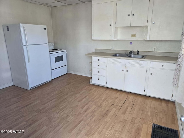 939 N W St, Lima, OH 45801 - kitchen featuring white appliances, light countertops, light wood-style flooring, white cabinetry, and a drop ceiling