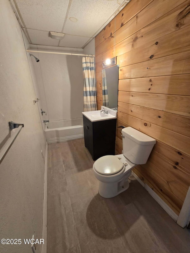 939 N W St, Lima, OH 45801 - full bathroom featuring vanity, shower / tub combo, wood finished floors, wood walls, and a paneled ceiling