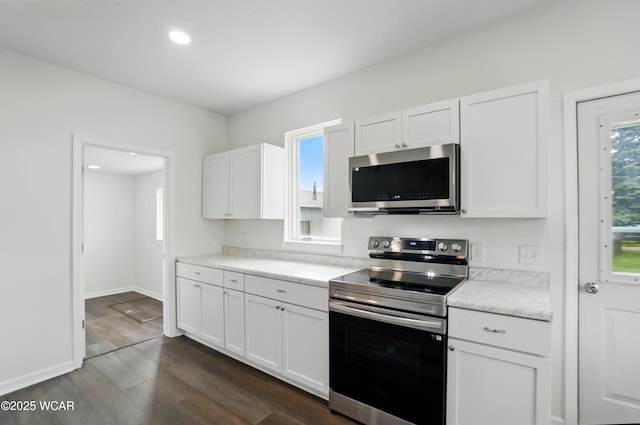 221 S Broadway St, Spencerville, OH 45887 - kitchen with stainless steel appliances, dark wood-type flooring, white cabinets, light countertops, and recessed lighting