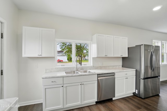 221 S Broadway St, Spencerville, OH 45887 - kitchen featuring appliances with stainless steel finishes, dark wood-type flooring, light countertops, and white cabinetry