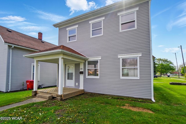 221 S Broadway St, Spencerville, OH 45887 - rear view of house featuring a lawn