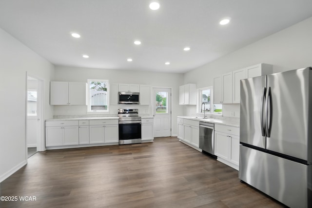 221 S Broadway St, Spencerville, OH 45887 - kitchen featuring appliances with stainless steel finishes, light countertops, white cabinetry, recessed lighting, and dark wood-type flooring