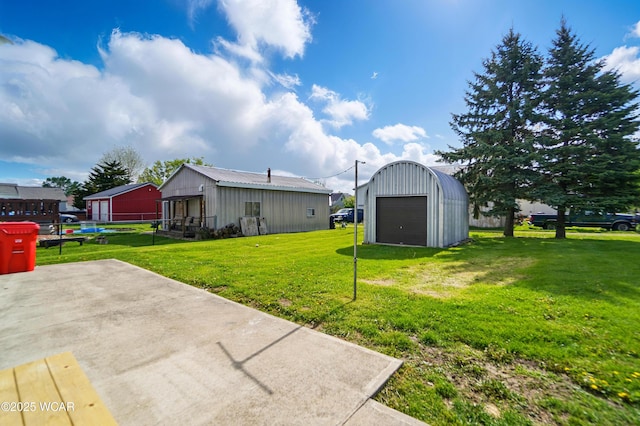 221 S Broadway St, Spencerville, OH 45887 - view of yard with an outdoor structure, a garage, and driveway