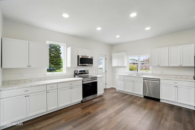 221 S Broadway St, Spencerville, OH 45887 - kitchen featuring stainless steel appliances, white cabinetry, dark wood finished floors, recessed lighting, and light countertops