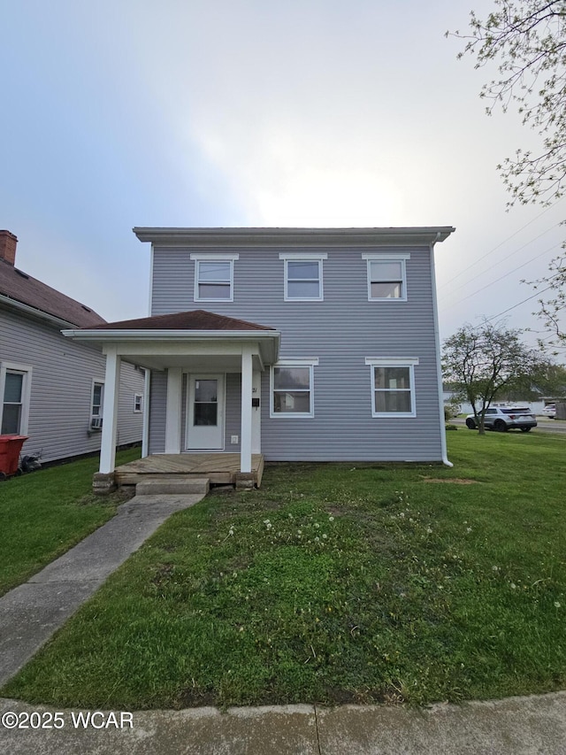 view of front facade with a front yard and covered porch