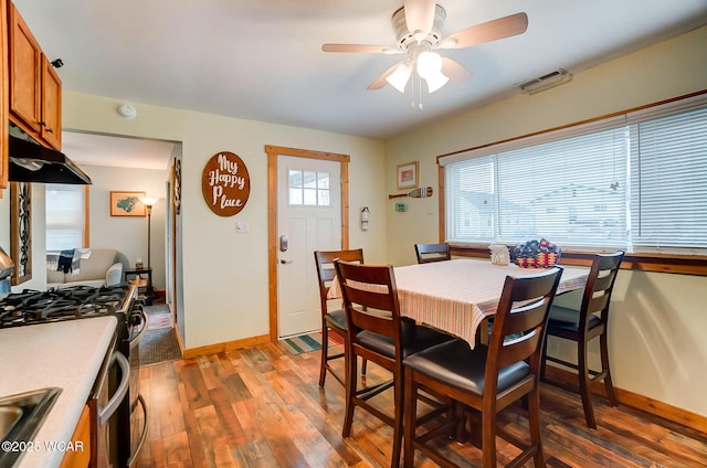 dining area with light wood-style floors, a ceiling fan, baseboards, and visible vents