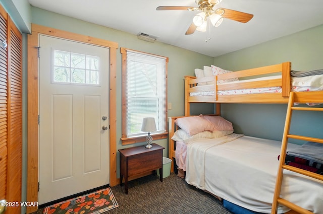bedroom with carpet floors, ceiling fan, and visible vents