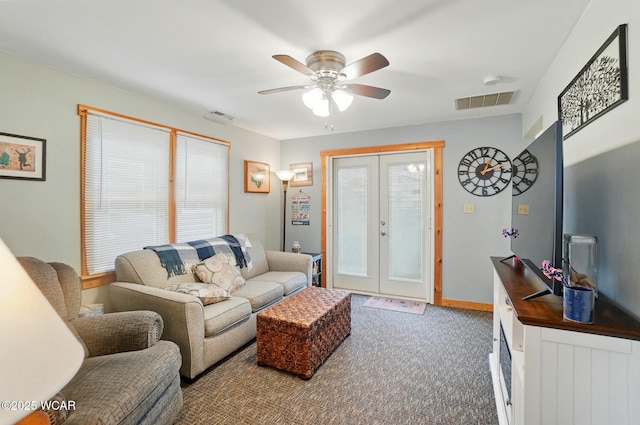 living room with french doors, ceiling fan, a wealth of natural light, and carpet floors