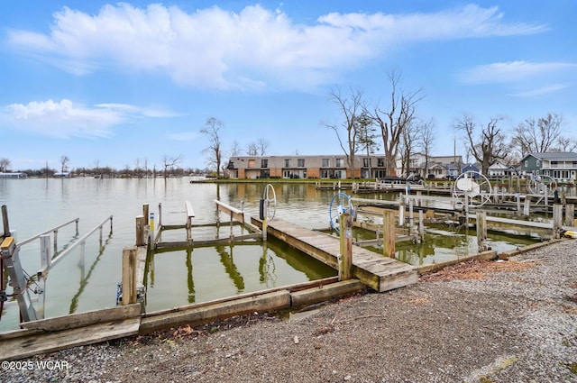 dock area featuring a water view and a residential view