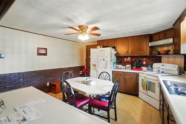 18698 Rd 48, Grover Hill, OH 45849 - kitchen with white appliances, under cabinet range hood, light countertops, a ceiling fan, and brown cabinetry
