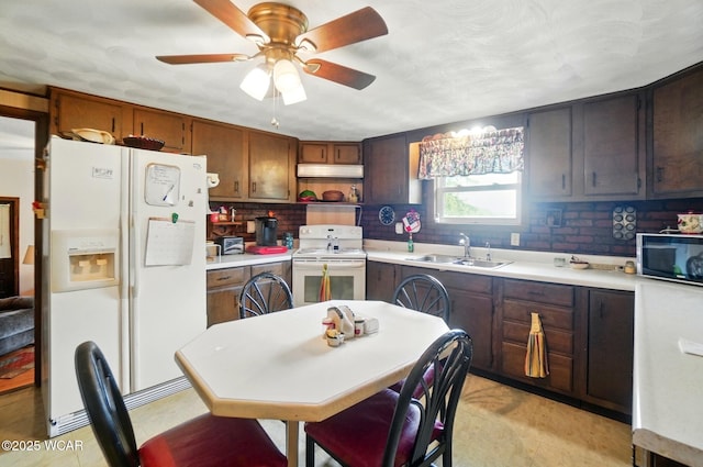 18698 Rd 48, Grover Hill, OH 45849 - kitchen featuring white appliances, a sink, under cabinet range hood, backsplash, and light countertops