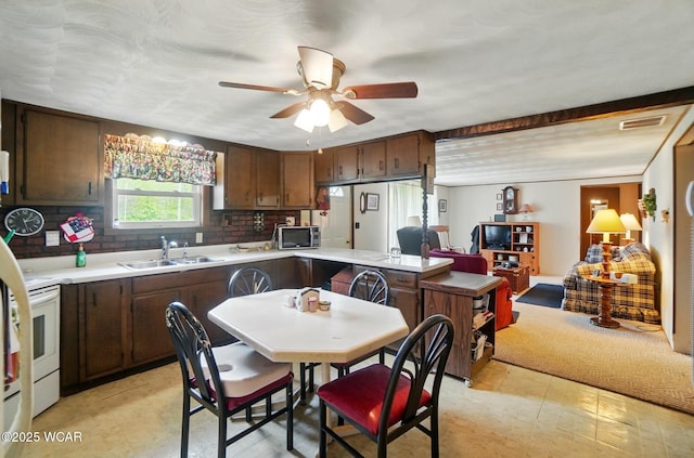 18698 Rd 48, Grover Hill, OH 45849 - kitchen with a sink, stainless steel microwave, light countertops, and a ceiling fan