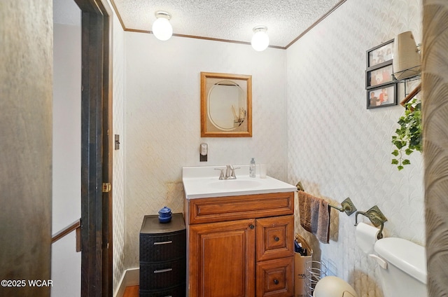 18698 Rd 48, Grover Hill, OH 45849 - half bath featuring wallpapered walls, ornamental molding, toilet, vanity, and a textured ceiling