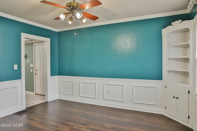 unfurnished room featuring ornamental molding, dark hardwood / wood-style flooring, ceiling fan, and a textured ceiling