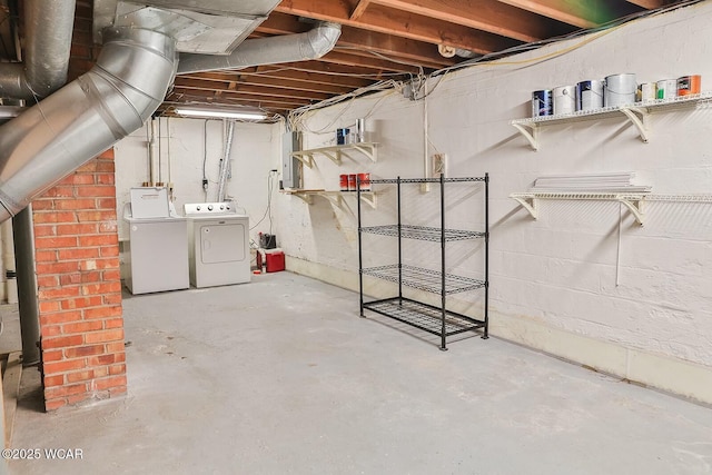 basement featuring electric panel and washer and dryer