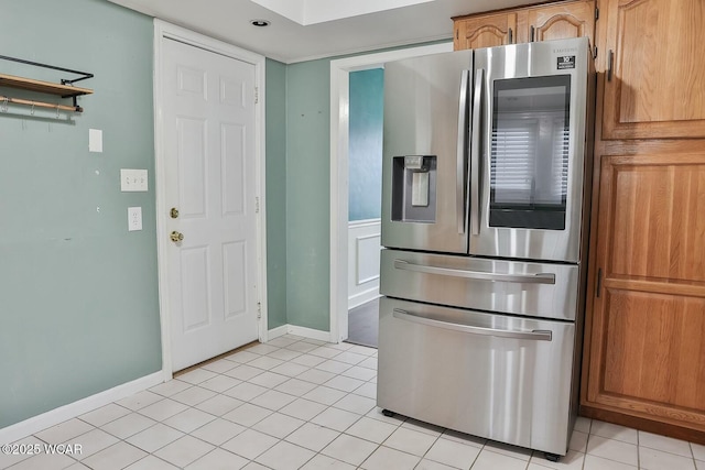 kitchen with light tile patterned floors and stainless steel refrigerator with ice dispenser