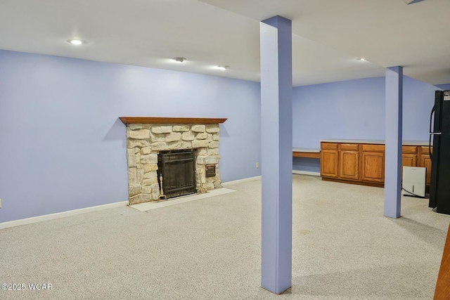 unfurnished living room with light carpet and a fireplace