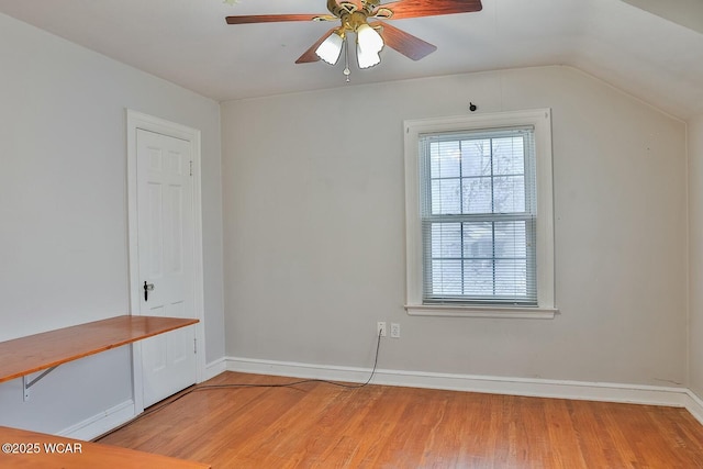 interior space with lofted ceiling, hardwood / wood-style floors, and ceiling fan