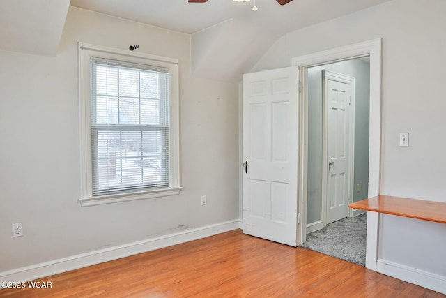 interior space with ceiling fan, wood-type flooring, and lofted ceiling