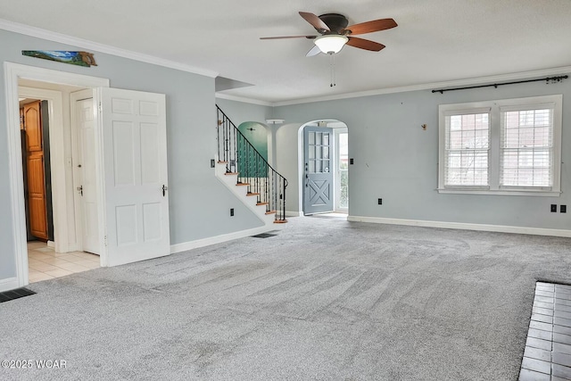 spare room with ornamental molding, a healthy amount of sunlight, and light carpet