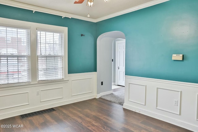 unfurnished room with dark wood-type flooring, ornamental molding, and ceiling fan