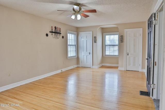 interior space with a textured ceiling, light hardwood / wood-style flooring, and ceiling fan