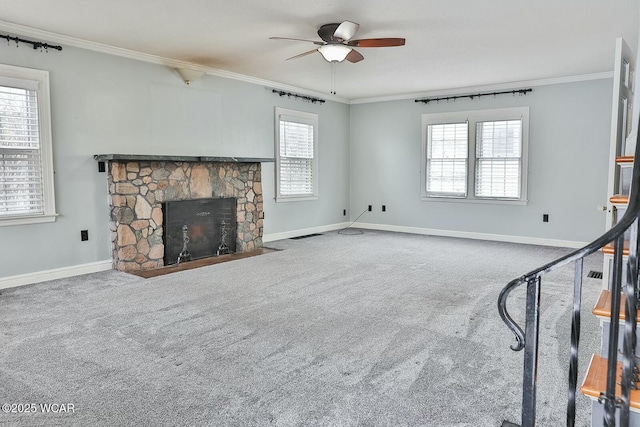 unfurnished living room featuring crown molding, carpet floors, a fireplace, and a healthy amount of sunlight