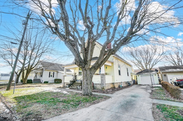 view of front of home featuring an outbuilding, a garage, and covered porch